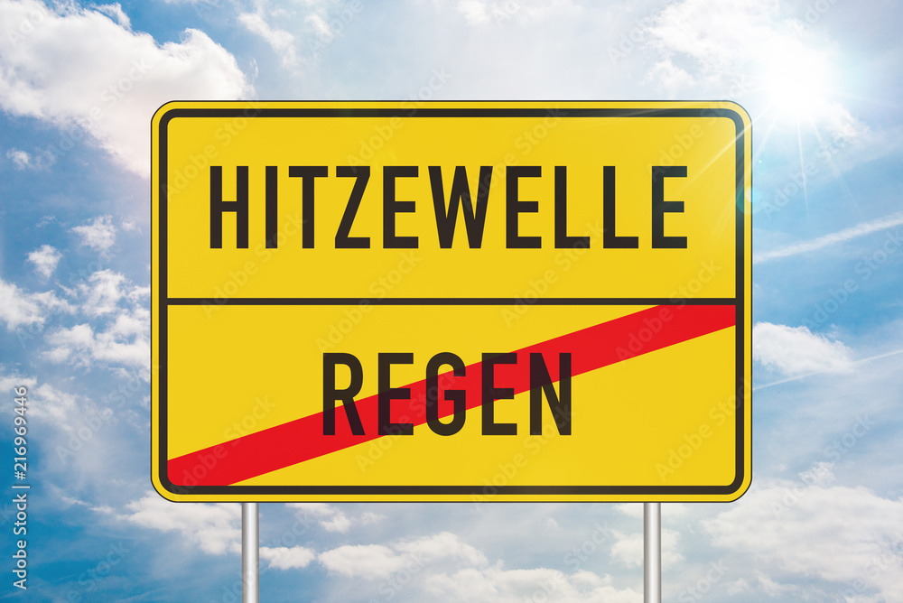 Yellow roadsign with heatwave and rain written in german against blue sky in background Yellow roadsign with heatwave and rain written in german against blue sky in background
