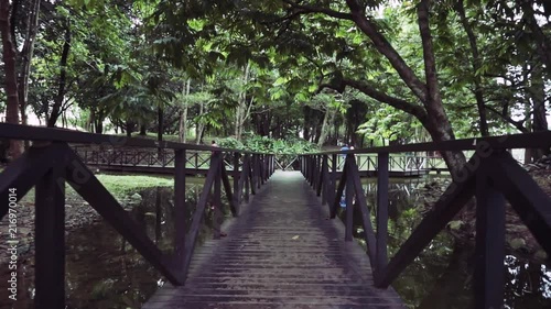 Steadicam stabilized gimbal shot of Wooden foot path Bridge, Slow Motion photo