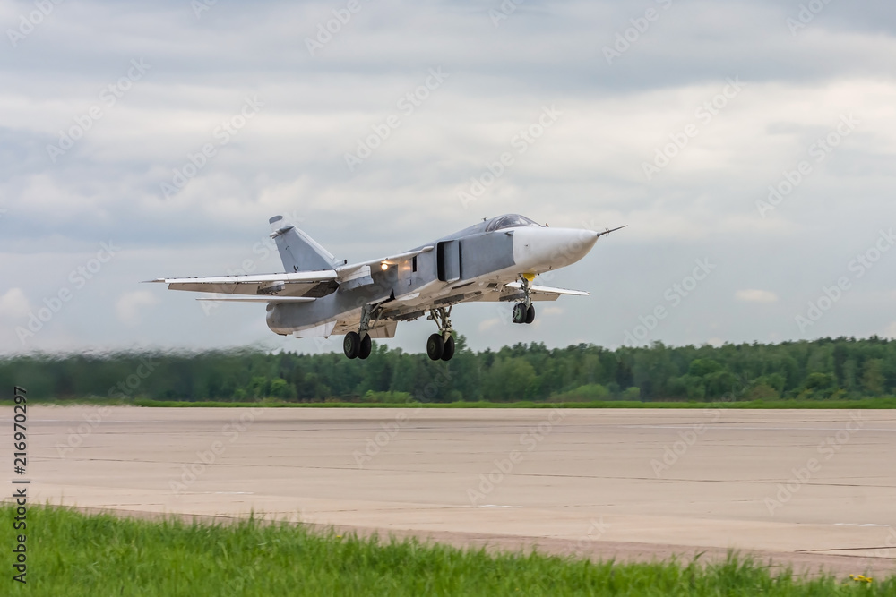 Air military bomber perfoming take off from the airbase runway in Russia. Air fighter flying around base. Aviation mission of military flight. Air military bomber perfoming take off from the airbase runway in Russia. Air fighter flying around base. Aviation mission of military flight.