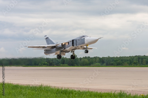 Air military bomber perfoming take off from the airbase runway in Russia. Air fighter flying around base. Aviation mission of military flight.