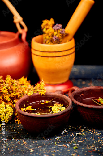 Healing herbs on wooden black table, herbal medicine