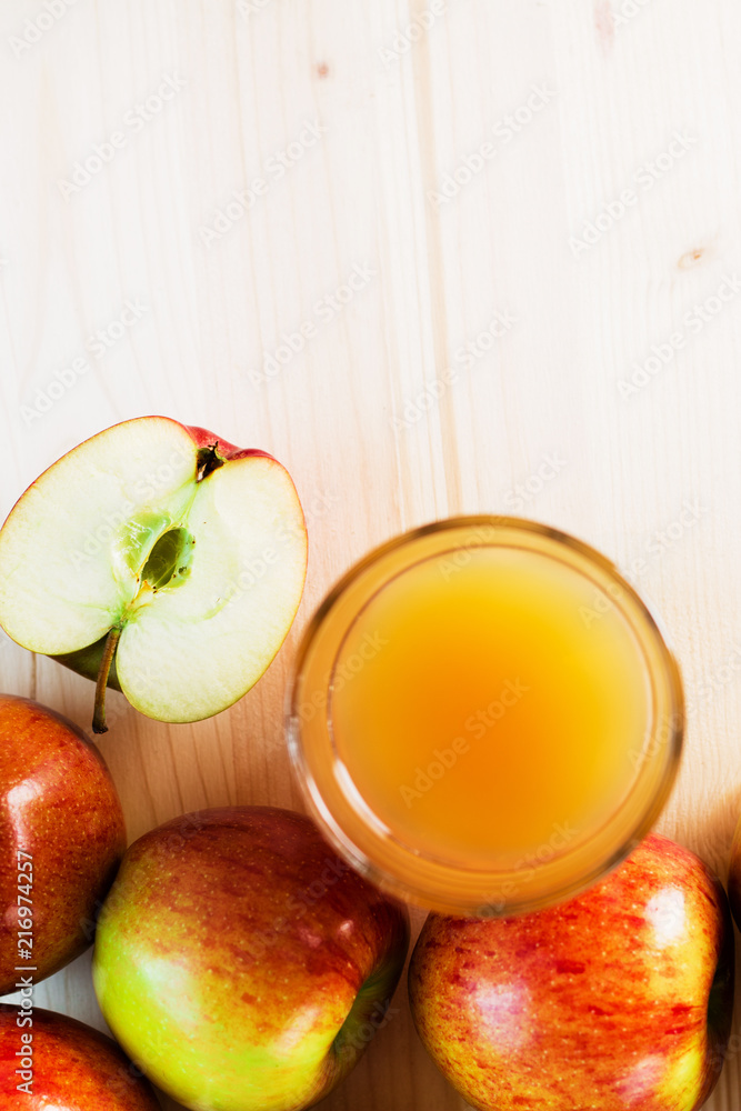Glass of fresh apple juice and half apple near autumn apples Glass of fresh apple juice and half apple near autumn apples