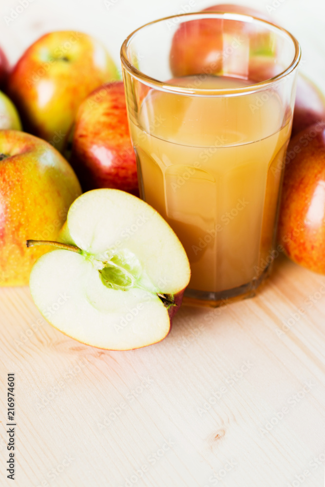 Glass of fresh apple juice and half apple near autumn apples. Glass of fresh apple juice and half apple near autumn apples.