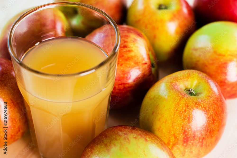 Glass of fresh apple juice near autumn apples Glass of fresh apple juice near autumn apples