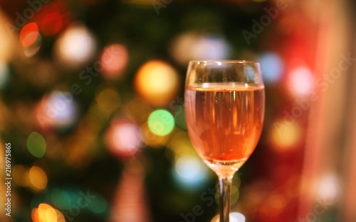 Glass of cocktails closeup blur Christmas tree lights decoration background