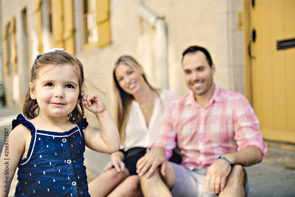 Parent and child girl having fun on old city street