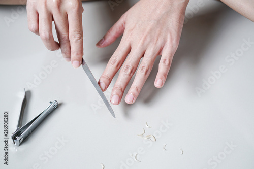 Woman Manicures Files Fingernails