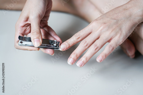 Closeup Woman Cutting her Nails