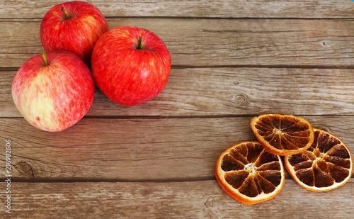 Still life of ripe apples and dried orange slices