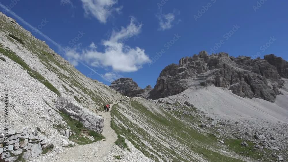 Tourists marching along the path that leads to the Forcella Lavaredo, Veneto, Italy Tourists marching along the path that leads to the Forcella Lavaredo, Veneto, Italy