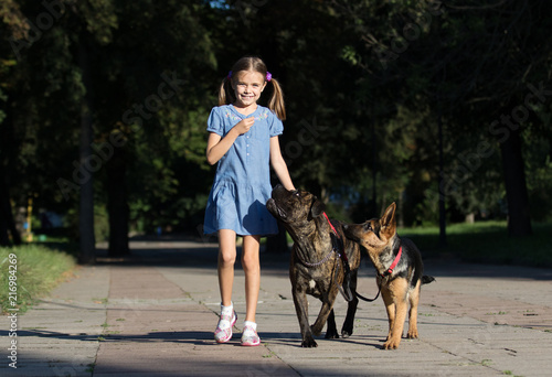 girl and dog walking in the park