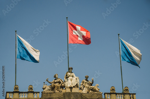 The roof of a Central train station in Zürich with Zürich canton flags and flag of Switzerland photo