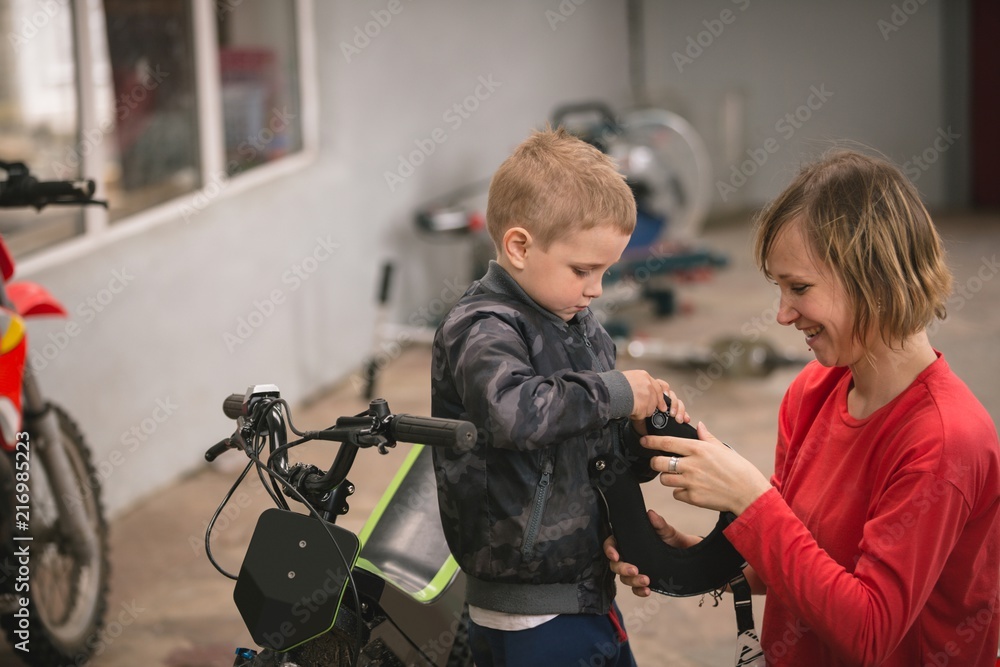 © Wavebreak Media - Mother preparing her son for bike riding