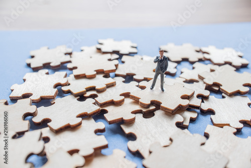 Miniature on wood jigsaw, Business concept