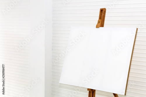 White canvas painting on wood drawing stand to creative for design and decoration.Copy space on background.