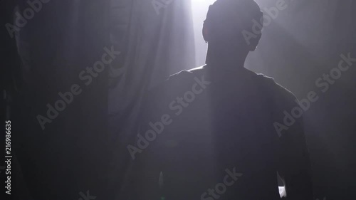 Basketball player waiting and going to play game or championnat, misty room with floodlight