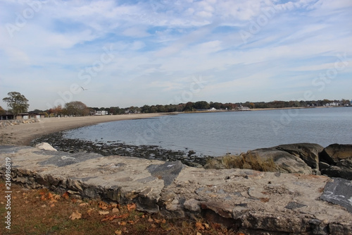 Rock wall barrier at the cove. Nice fall morning at the beach during low tide. Autumn in New England