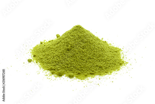 Powdered matcha green tea scattered on white background