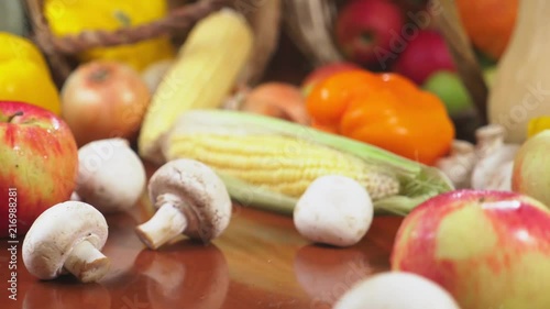 Autumnal Harvest or Thanksgiving, Cornucopia filled with vegetables, vegetables spilled out of the basket on the table. 4k, dolly shot photo