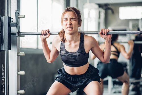 Fitness woman lifting weight in gym