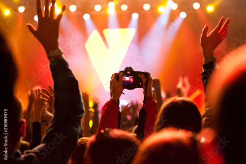 cheering crowd with raised hands at concert - music festival