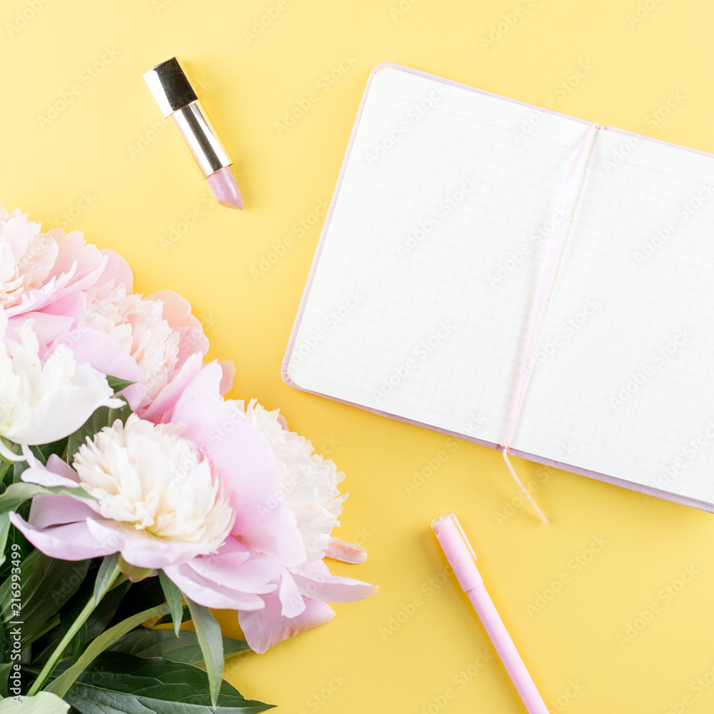 Flat lay home office desk. Feminine workspace with open blank note book, peony flowers, eyeglasses. Flat lay home office desk. Feminine workspace with open blank note book, peony flowers, eyeglasses.