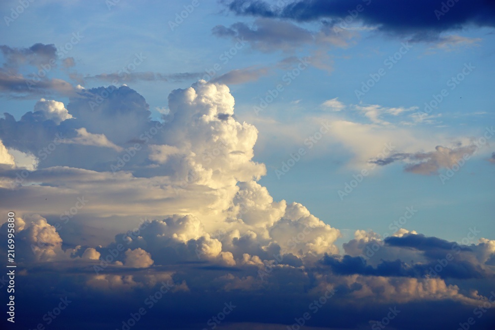 Dramatic cloudscape horizontal background with blue sky and colorful clouds - obrazy, fototapety, plakaty 