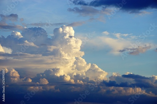 Dramatic cloudscape horizontal background with blue sky and colorful clouds