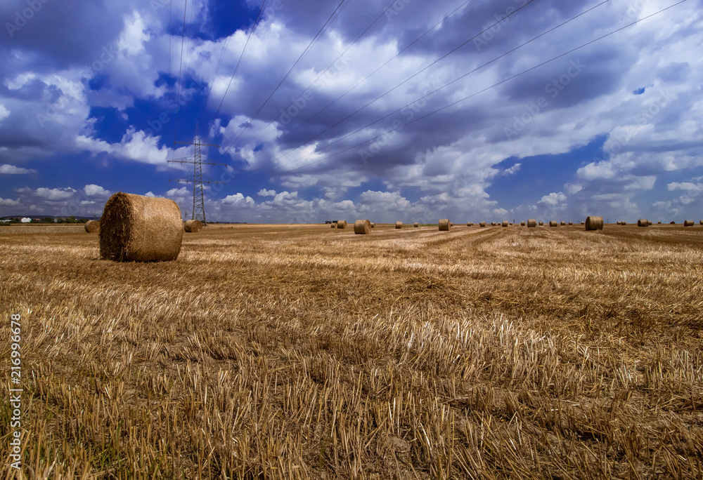 of hay bales and clouds 
