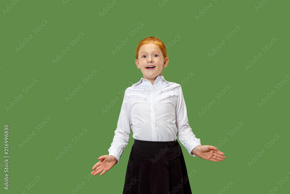 Wow. Beautiful female half-length front portrait isolated on green studio backgroud. Young emotional surprised teen girl standing with open mouth. Human emotions, facial expression concept. Trendy Wow. Beautiful female half-length front portrait isolated on green studio backgroud. Young emotional surprised teen girl standing with open mouth. Human emotions, facial expression concept. Trendy