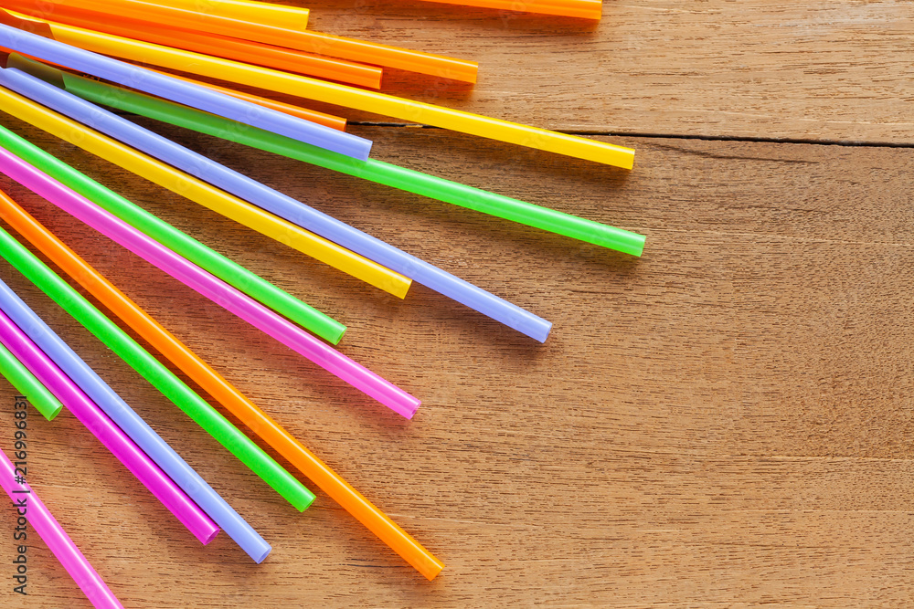 Colorful Straw on wood table background. Colorful Straw on wood table background.