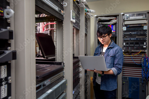 Foto Engineer configure data center on laptop.