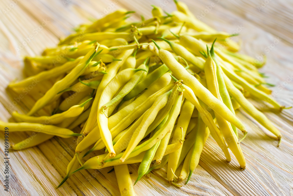 yellow beans on a wooden background top view. yellow beans on a wooden background top view.