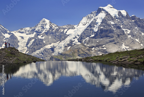 Summer in the Swiss Alps, Murren area, overlooking the Monch and Jungfrau mountains reflected in Grauseewli Lake, Canton of Bern, Switzerland, Europe