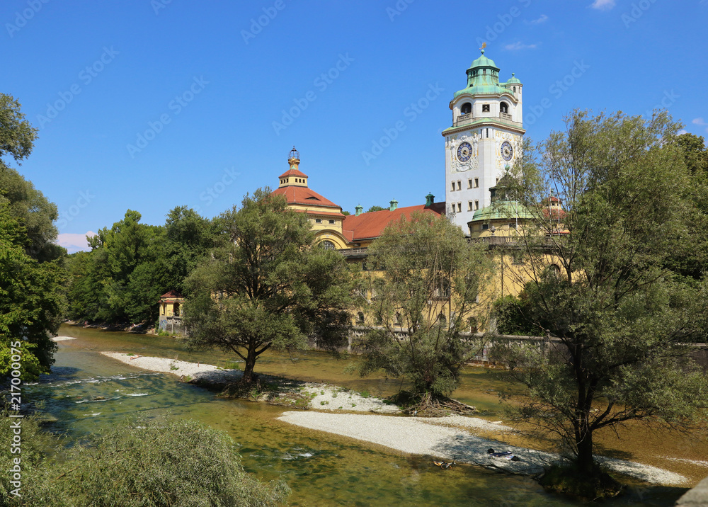 Summer view of the Isar river with the neo-baroque bath establishment Muellersches volksbad built in 1901 in Munich, Germany
