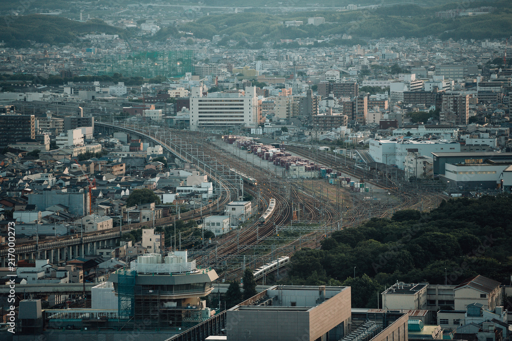 Japanese local railway and train station on cityscape in film vintage style