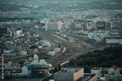 Japanese local railway and train station on cityscape in film vintage style photo