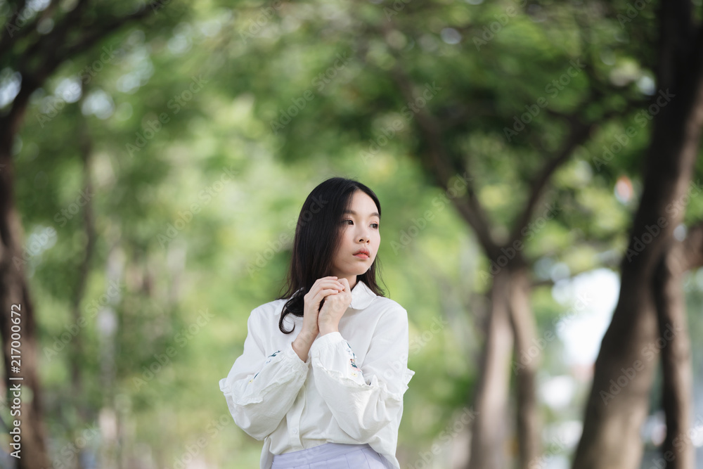 portrait of asian girl with white shirt and skirt looking in outdoor nature vintage film style portrait of asian girl with white shirt and skirt looking in outdoor nature vintage film style