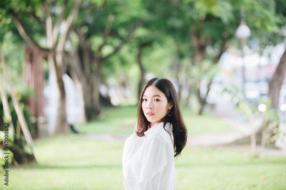 portrait of asian girl with white shirt and skirt looking in outdoor nature vintage film style portrait of asian girl with white shirt and skirt looking in outdoor nature vintage film style