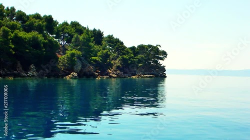 Peaceful blue water a the side of an island