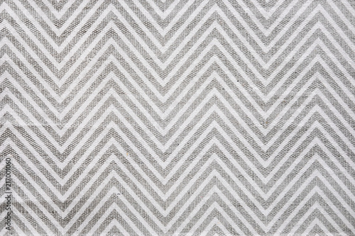 Chevron patterned carpet rug runner in white and gray. Close up