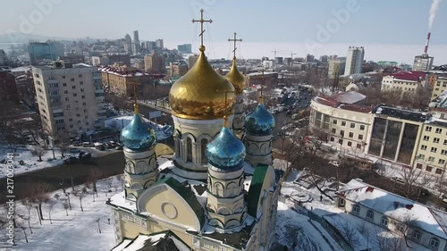 Drone Around Golden domes Orthodox chapel Intercession Mother God Reconstruction old Authentic ancient historical Religion cross Russia Vladivostok cityscape Culture Park Road traffic. Winter snow. 4k photo