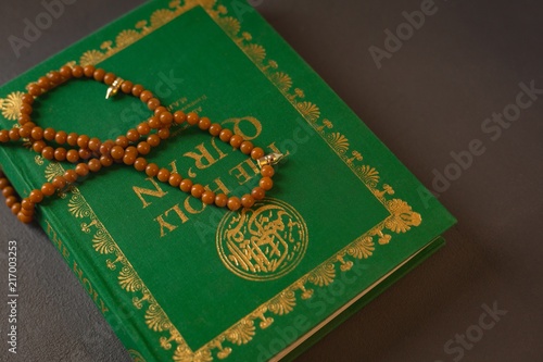 Prayer beads kept on holy Quran photo