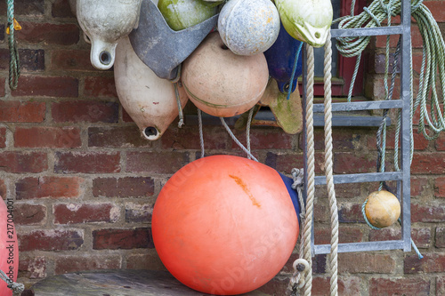 Bojen und Fischerzubehoer in einem Hafen in Wales photo