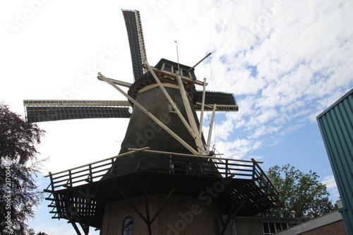 Old dutch windmill in village named Oldebroek with name De Hoop, still working as peel and as grind mill