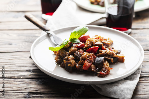 Traditional sicilan eggplant dish caponata on the wooden table, selective focus photo