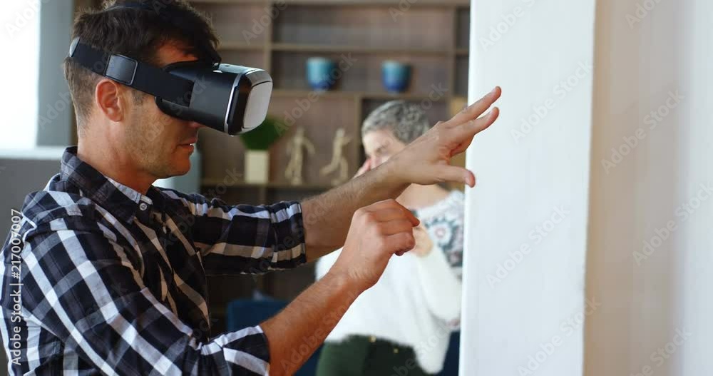 Executive using virtual reality headset while colleague talking on mobile phone in background 4k Executive using virtual reality headset while colleague talking on mobile phone in background 4k