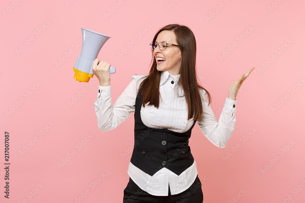 Young smiling business woman in glasses holding megaphone spreading hands looking aside isolated on pastel pink background. Lady boss. Achievement career wealth concept. Copy space for advertisement. Young smiling business woman in glasses holding megaphone spreading hands looking aside isolated on pastel pink background. Lady boss. Achievement career wealth concept. Copy space for advertisement.