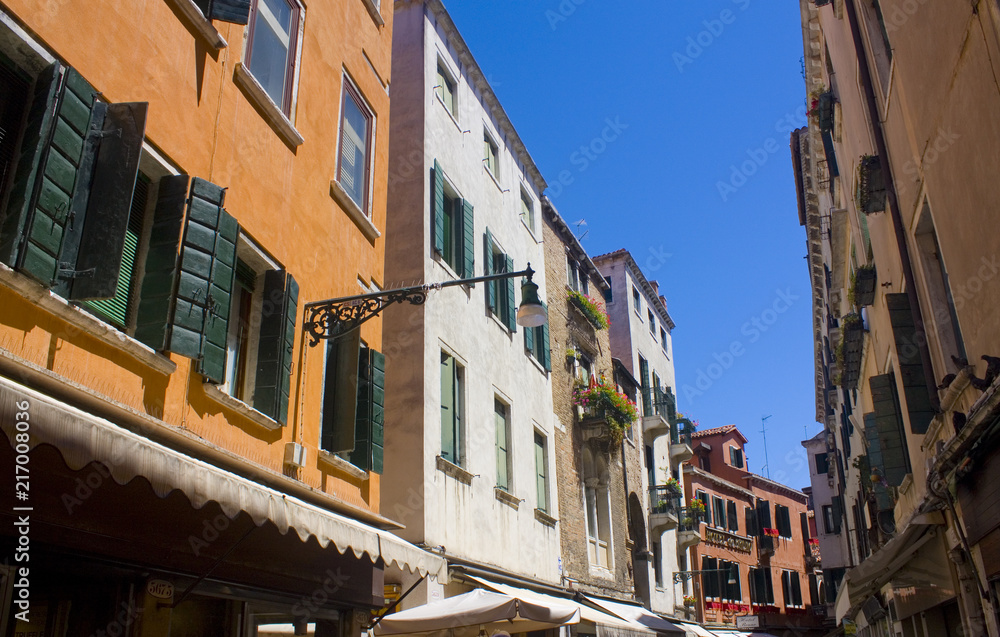 Architecture of narrow street of Venice at sunny day, Italy