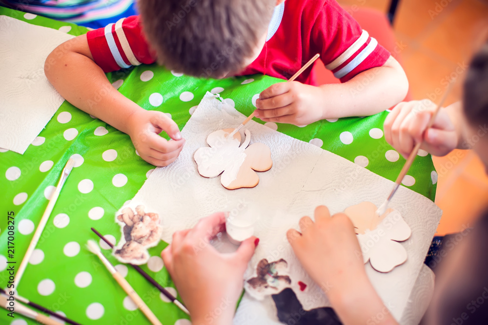 Children hands making artworks with wood and paint crafts. workplace ...